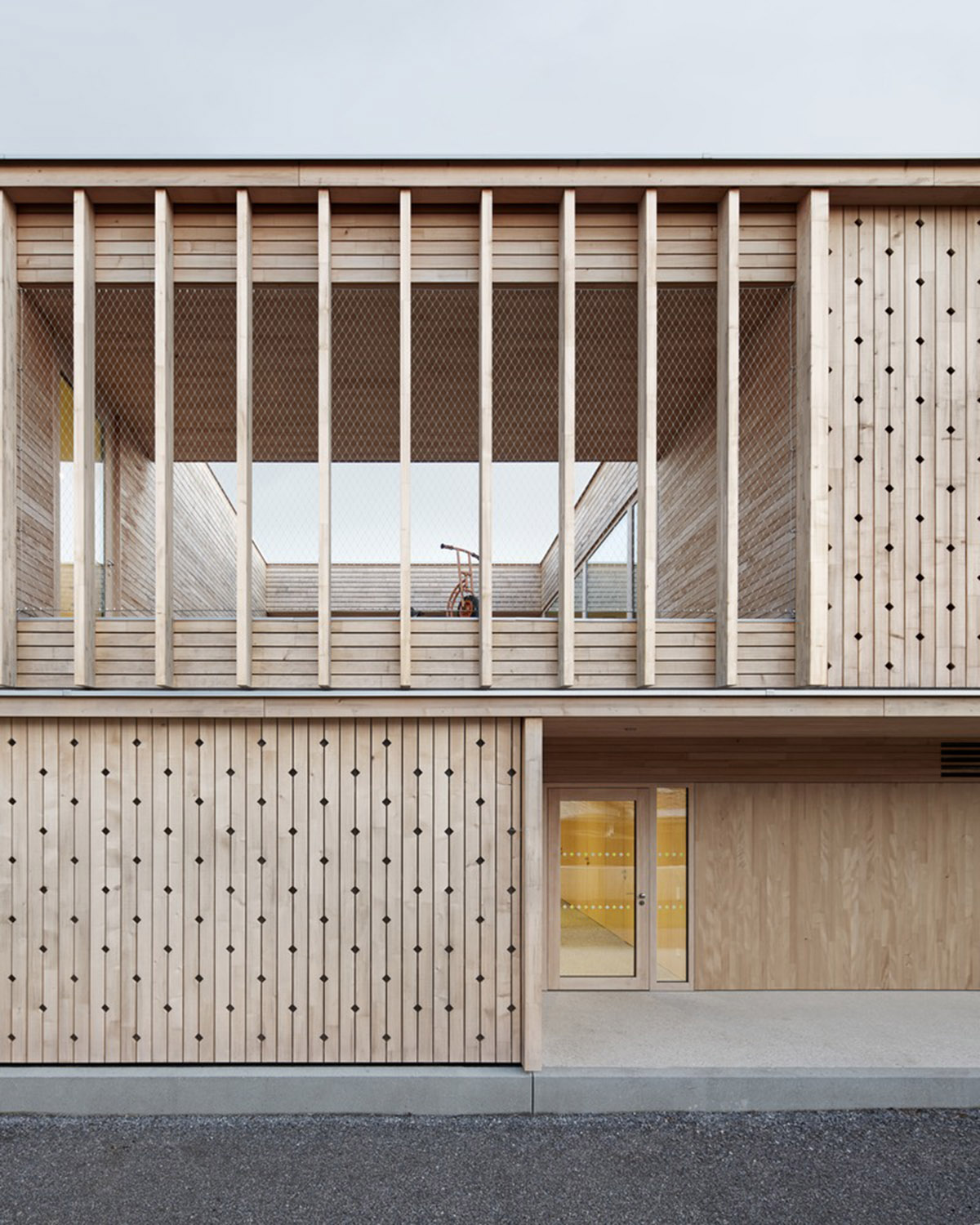 Innauer-Matt Architekten designs kindergarten with large pointed windows and wall motifs in Austria