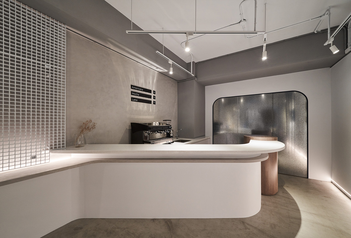 Republic Design reveals its coffee shop and gallery with curvy and white elements in Taiwan