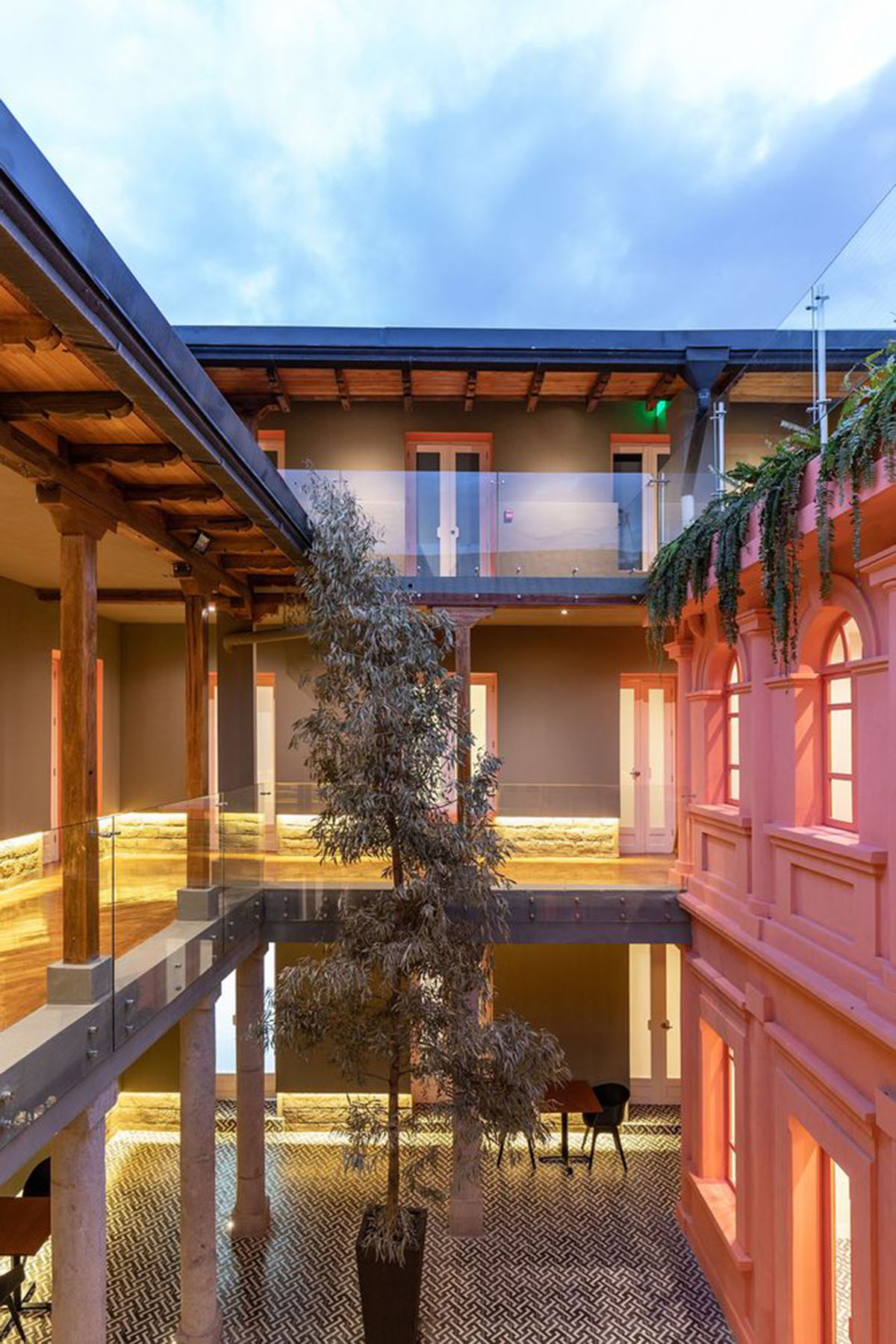 nicolas&nicolas converts old building into hotel with pinkish walls and central courtyard in Quito