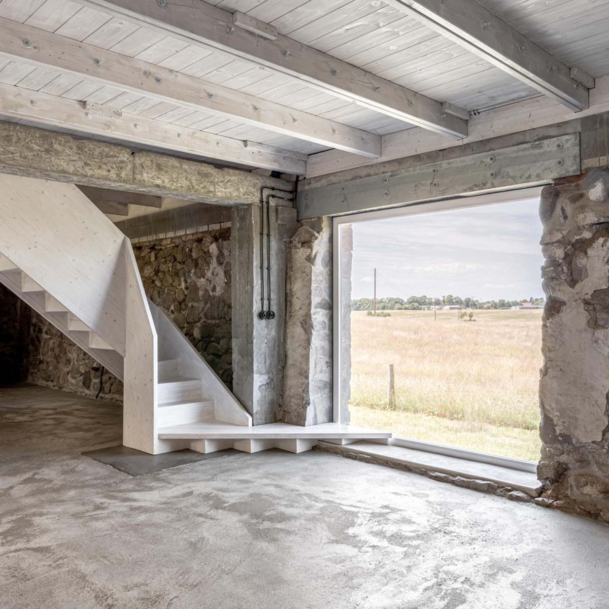 Helga Blocksdorf Architektur converts old barn into a photography studio incorporating natural tones 