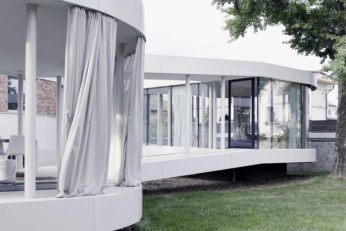 OFIS Architects renovates 1930s house with colonnaded and sloped pavilion in Slovenia 