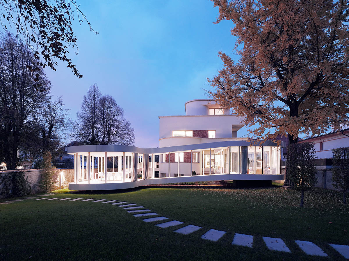 OFIS Architects renovates 1930s house with colonnaded and sloped pavilion in Slovenia 