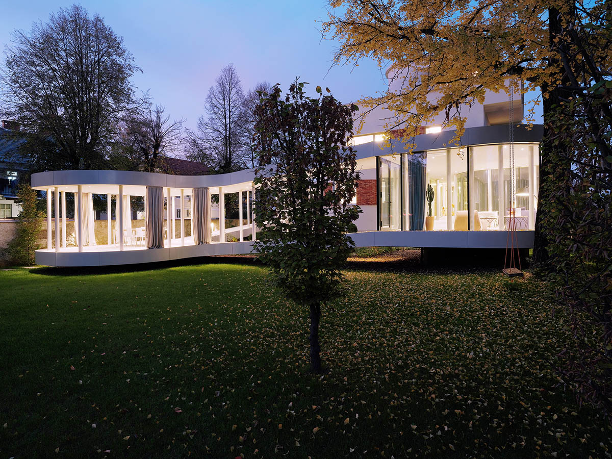 OFIS Architects renovates 1930s house with colonnaded and sloped pavilion in Slovenia 
