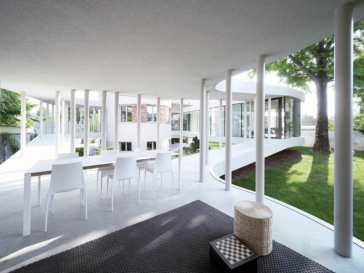 OFIS Architects renovates 1930s house with colonnaded and sloped pavilion in Slovenia 