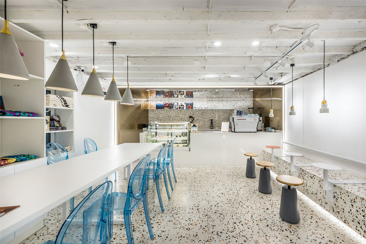 This tiny cafe by TOUCH Design is dotted with white and orange interwoven terrazzo details in Tianjin