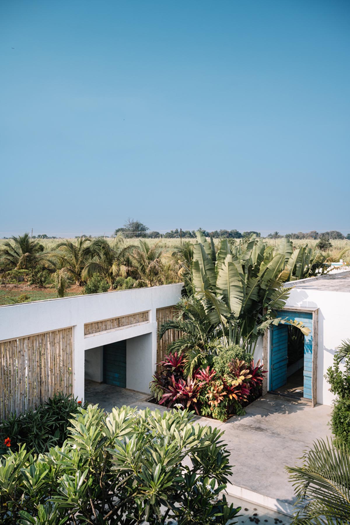 Weekend home is clad in bamboo screens that create a rustic appearance on the outskirts of Pune