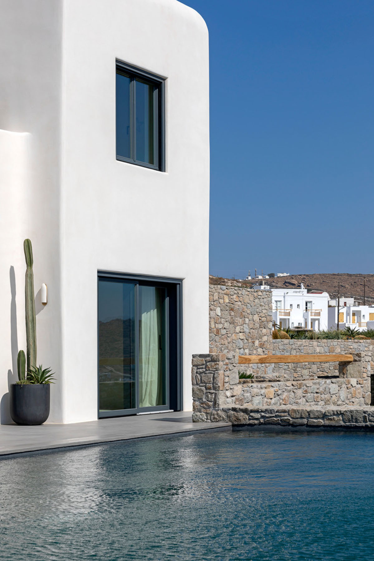 MK Design Studio designs luxurious holiday villa with creamy white walls and stone-walled terraces