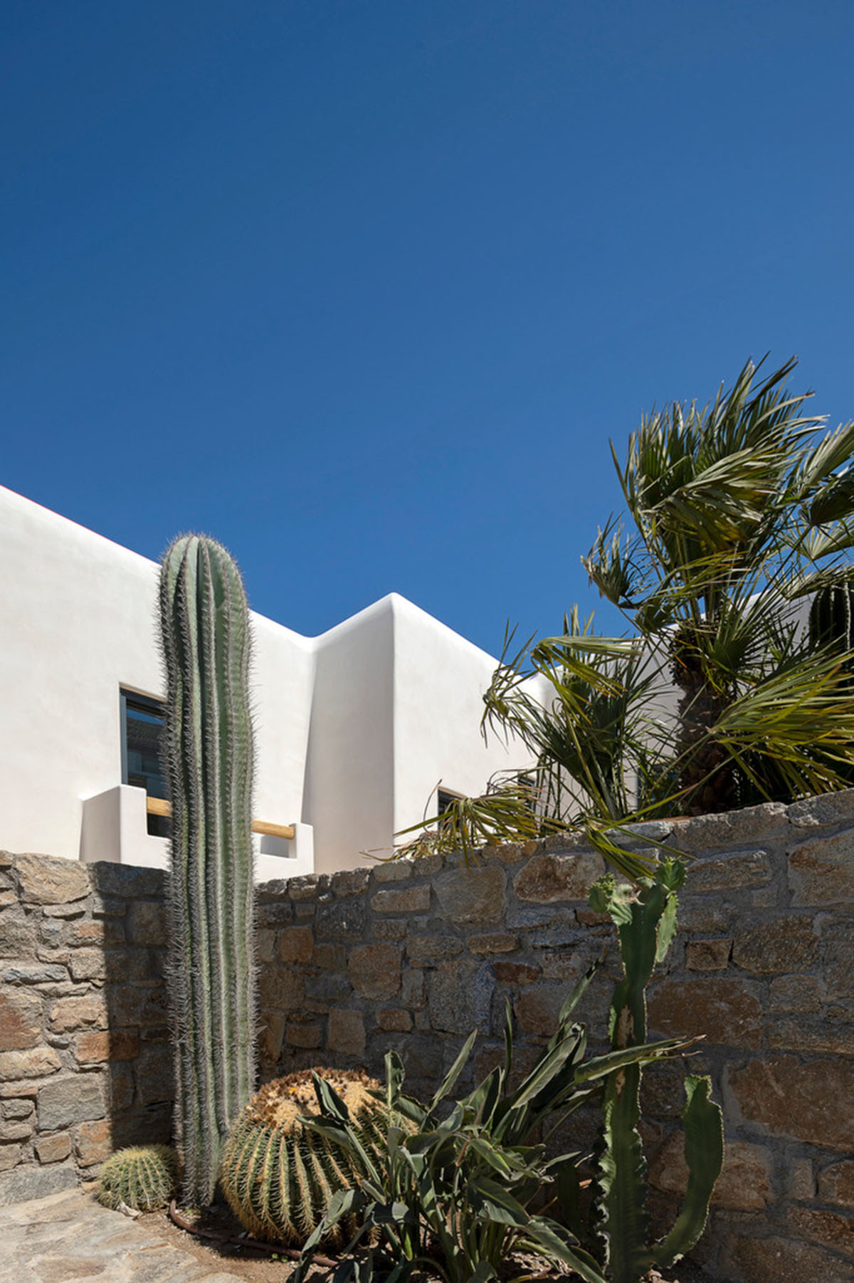 MK Design Studio designs luxurious holiday villa with creamy white walls and stone-walled terraces