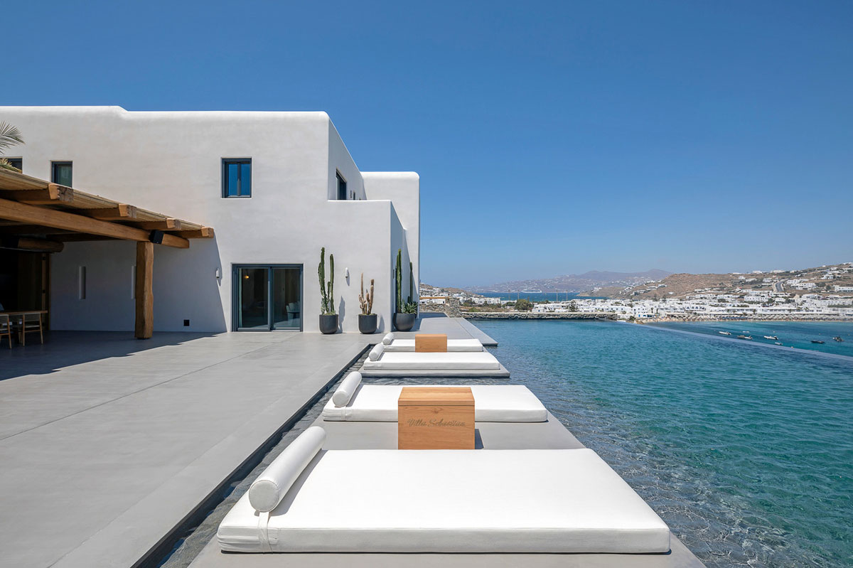 MK Design Studio designs luxurious holiday villa with creamy white walls and stone-walled terraces