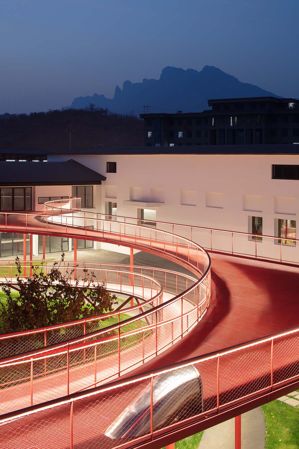 REDe Architects and Moguang Studio add red circular platform to renovated youth activity center