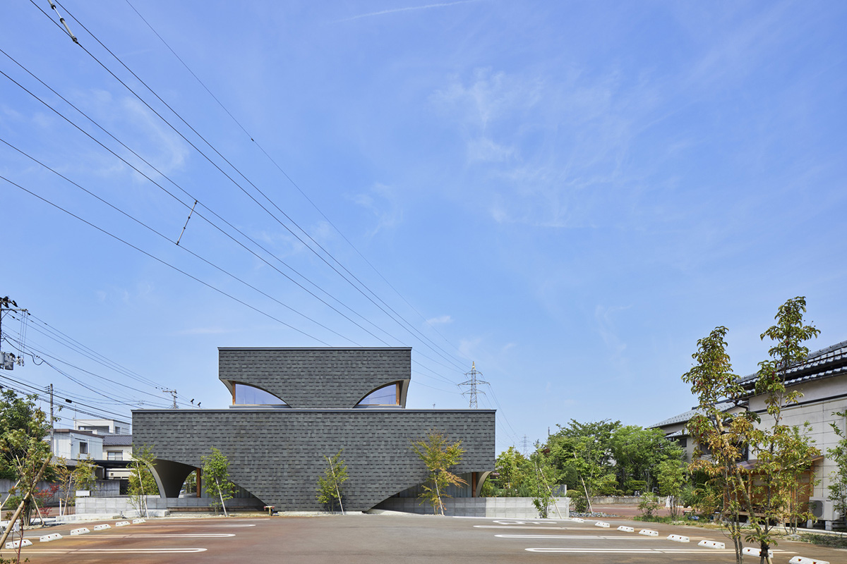 A dental clinic and daycare center are hidden under arches in Japan by Takeru Shoji Architects