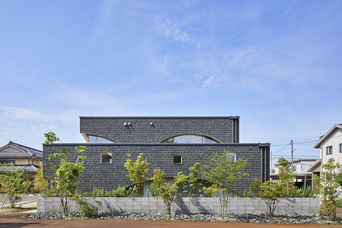 A dental clinic and daycare center are hidden under arches in Japan by Takeru Shoji Architects