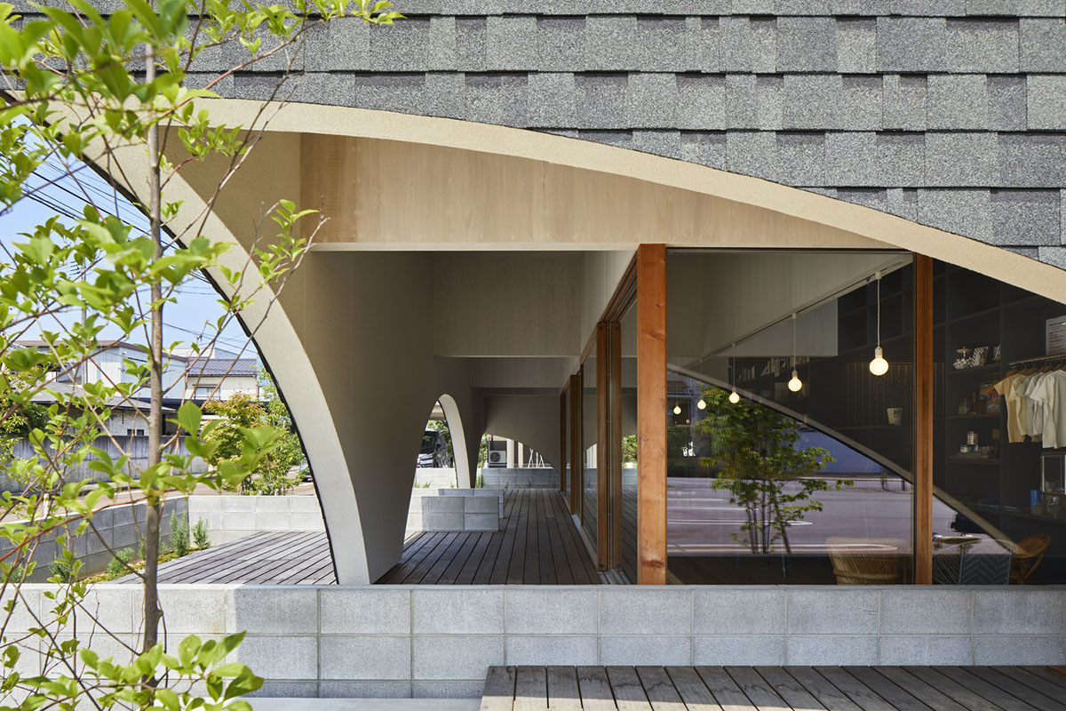 A dental clinic and daycare center are hidden under arches in Japan by Takeru Shoji Architects