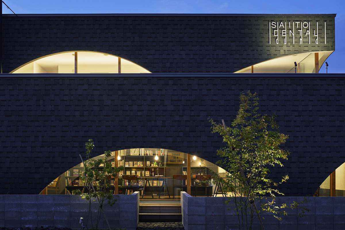 A dental clinic and daycare center are hidden under arches in Japan by Takeru Shoji Architects