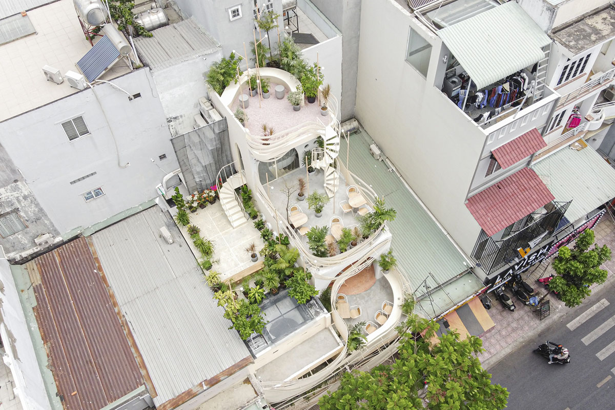 September Cafe is designed to look like a bird's nest with curved steel stripes in Vietnam