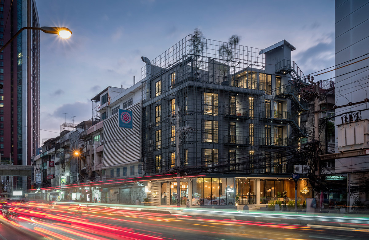 SIM Studio converts old shophouse into a boutique hotel by wrapping with steel exoskeleton in Bangkok