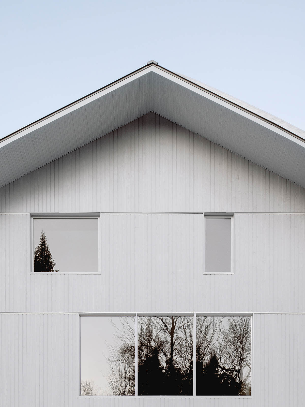 Canadian winter home designed by Atelier L'Abri looks like it is covered in  snow in the forest