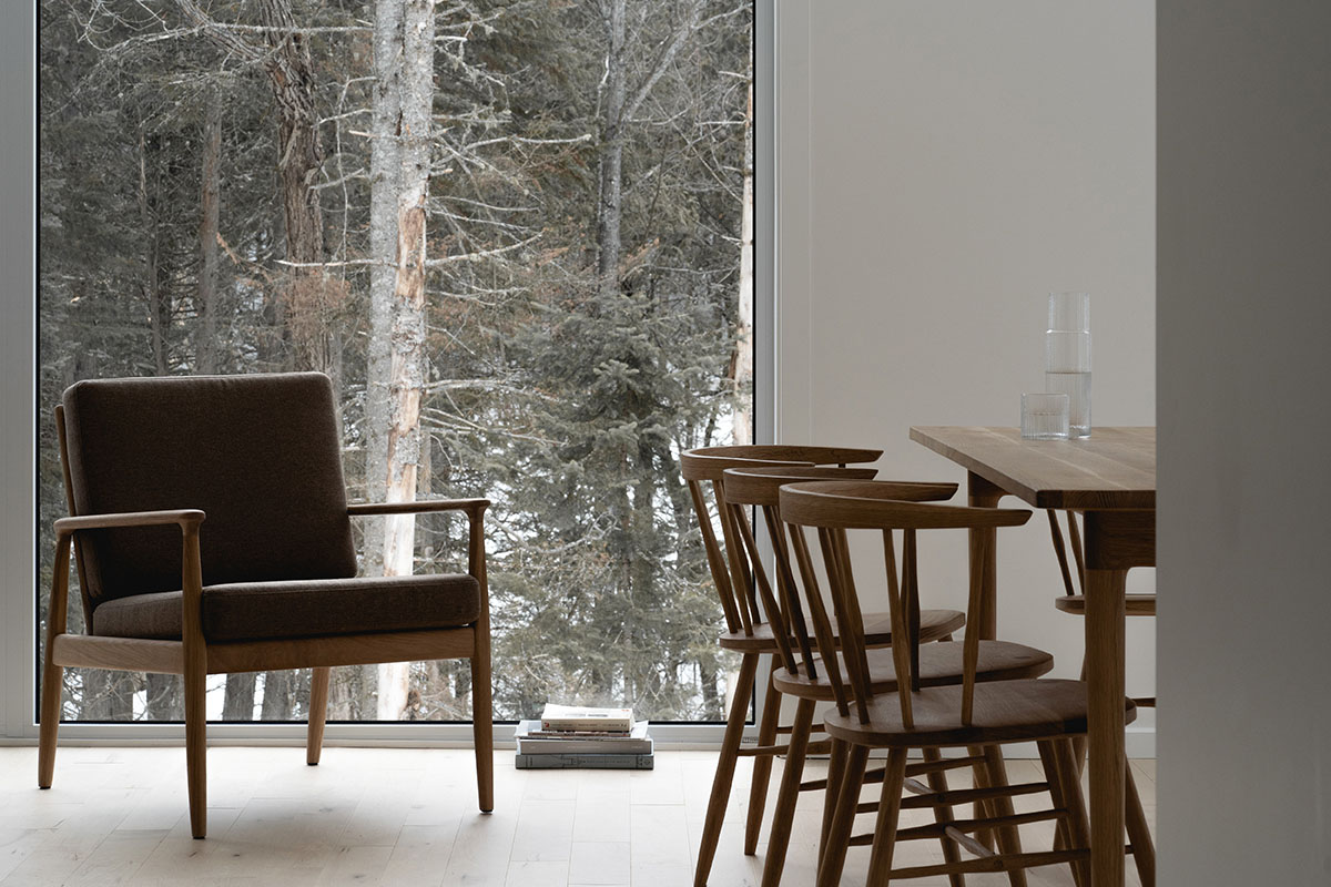 Canadian winter home designed by Atelier L'Abri looks like it is covered in  snow in