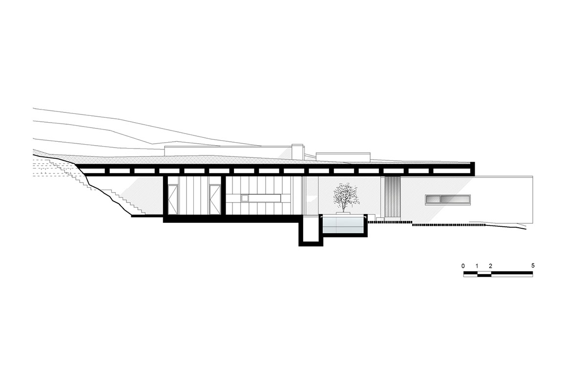 Swimming pool is bravely extended from inside of this concrete house towards endless view in Tinos