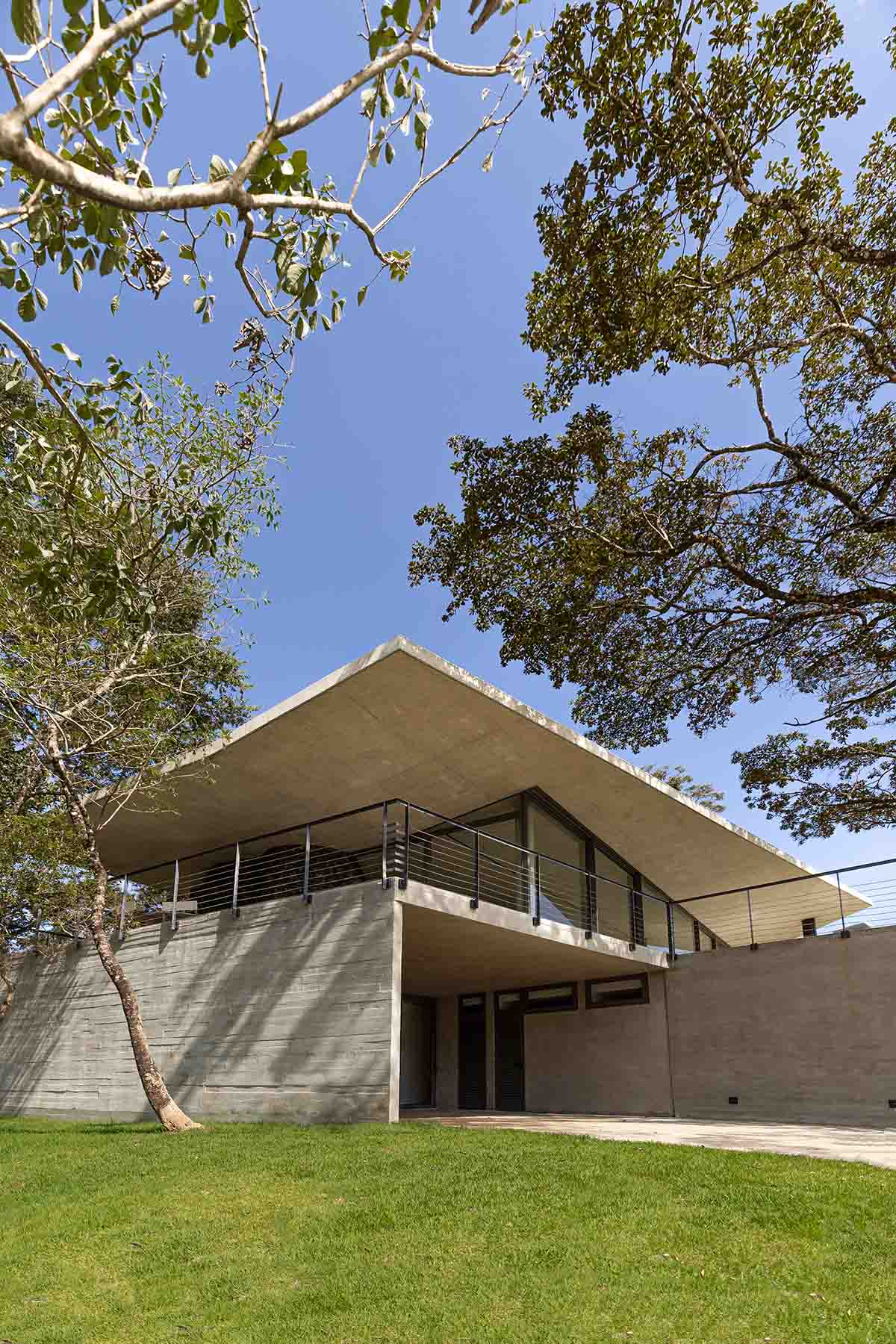 Seriema House is shaped around massive, black Portuguese stones for contemplation in Brazil