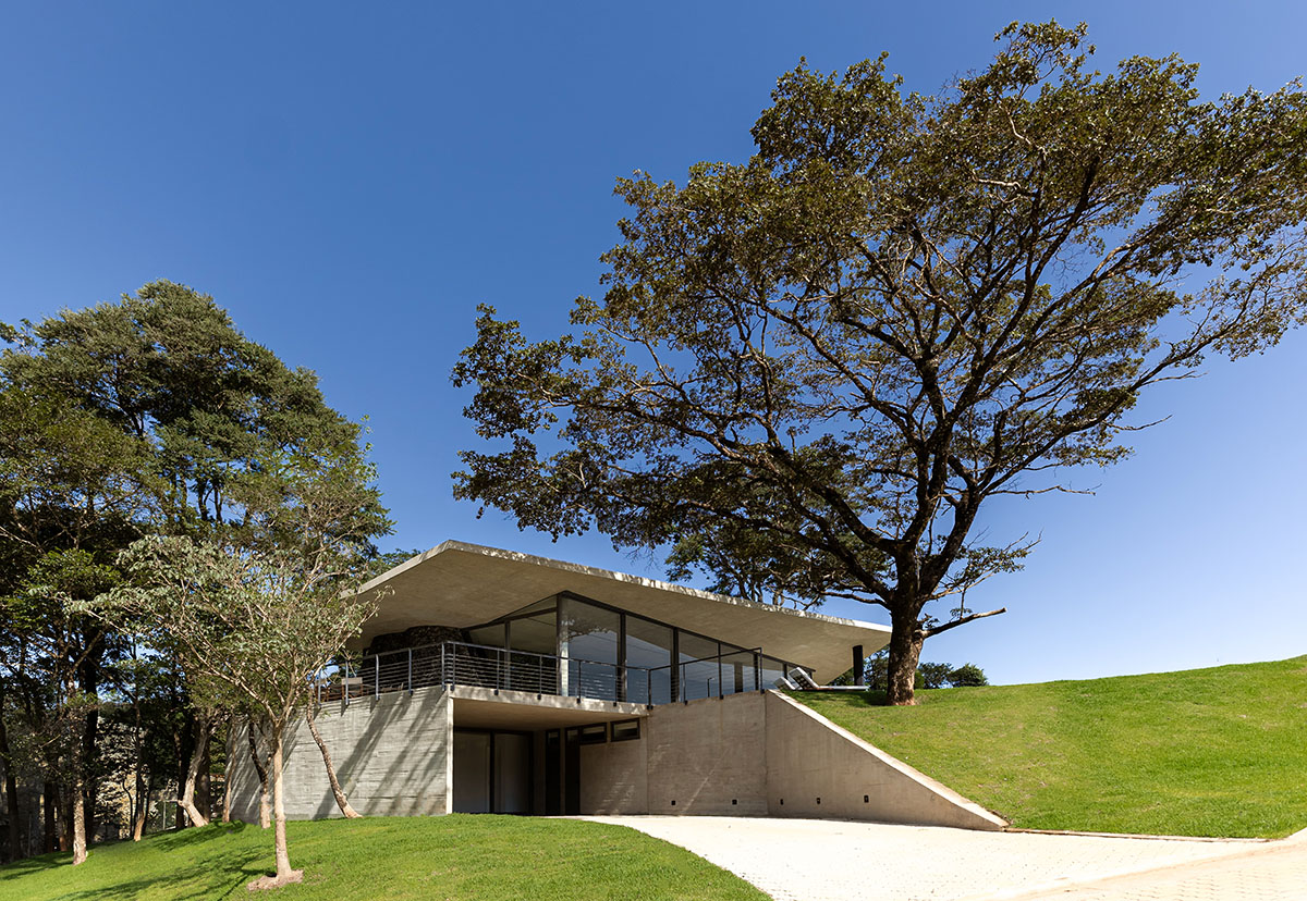 Seriema House is shaped around massive, black Portuguese stones for contemplation in Brazil