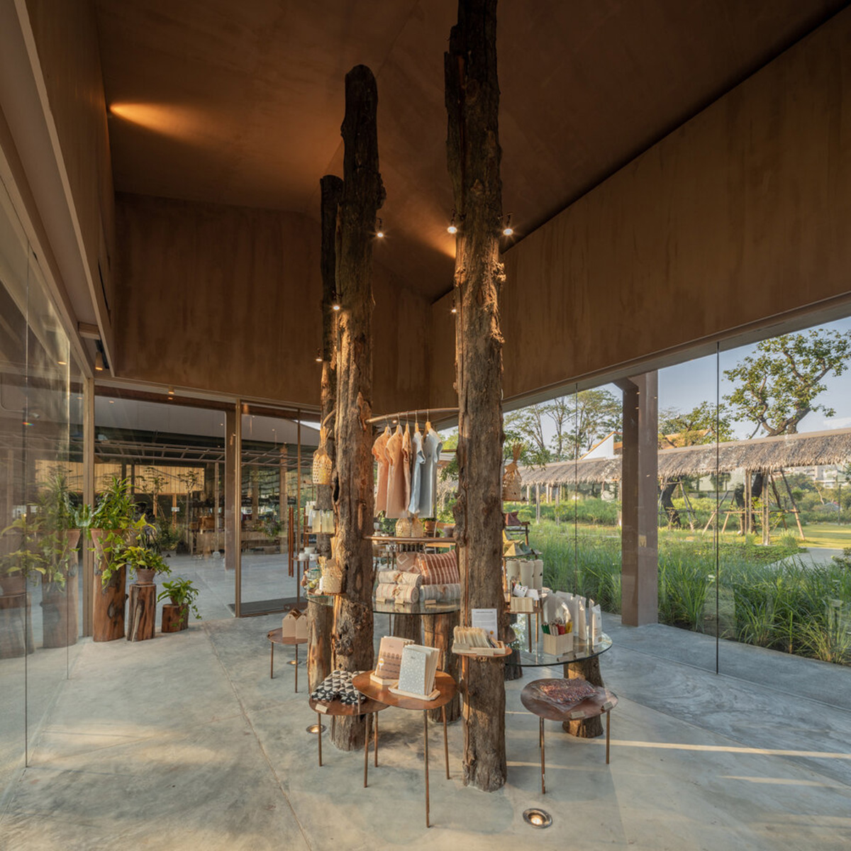 NITAPROW designed Patom Cafe with four segmented roof and thatched-roof walkway in Thailand