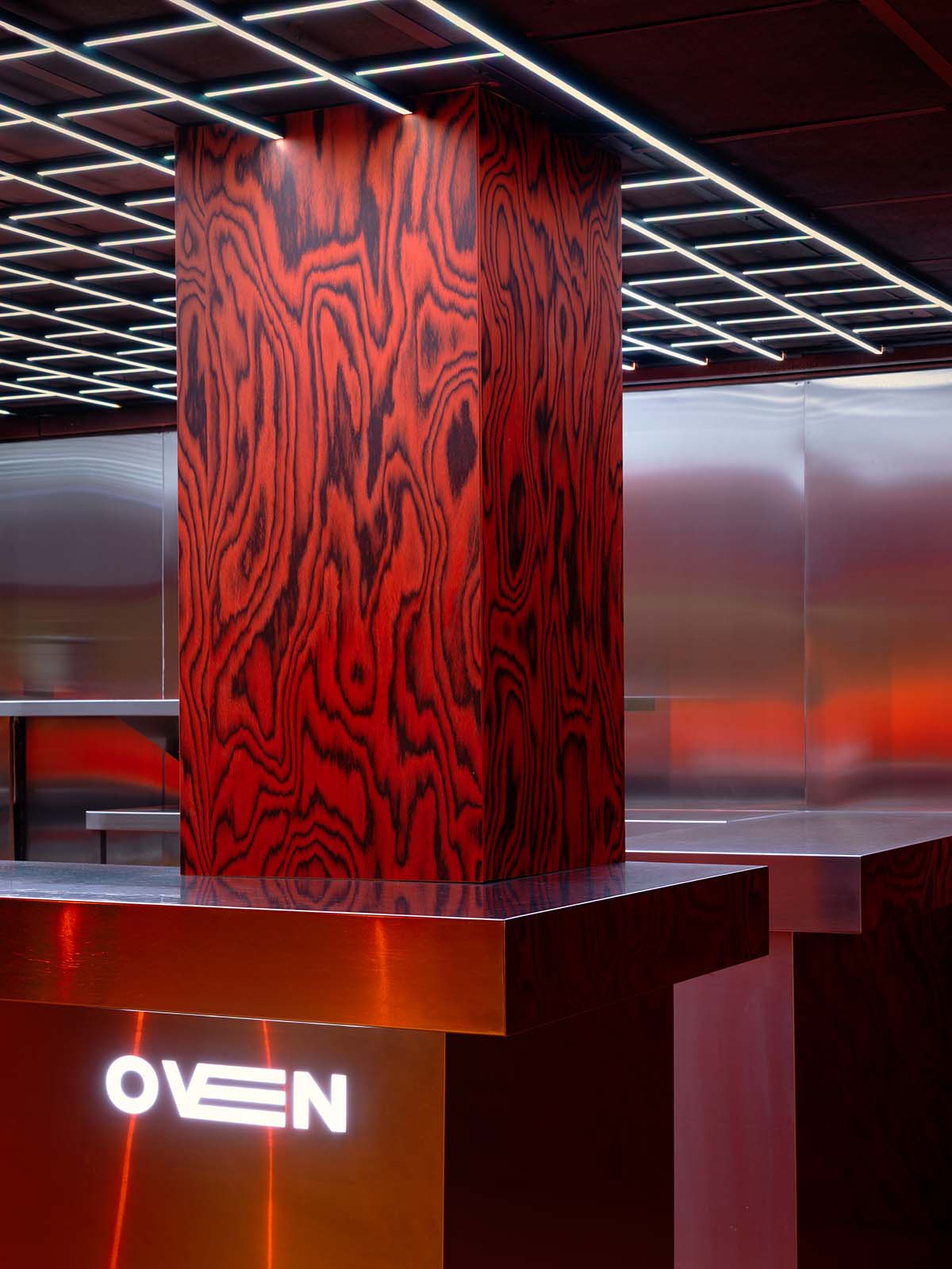 Bold red and black surfaces dominate the interior of the Oven Club, designed by Clap Studio