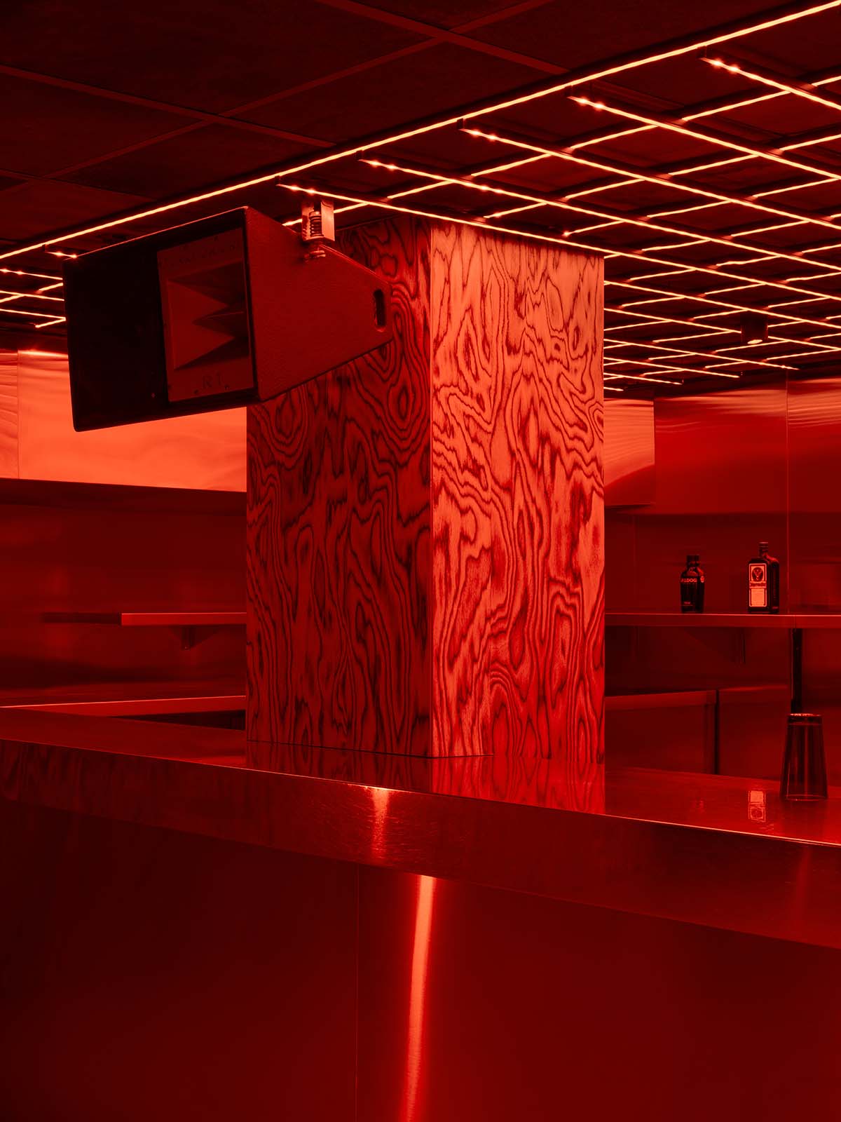 Bold red and black surfaces dominate the interior of the Oven Club, designed by Clap Studio