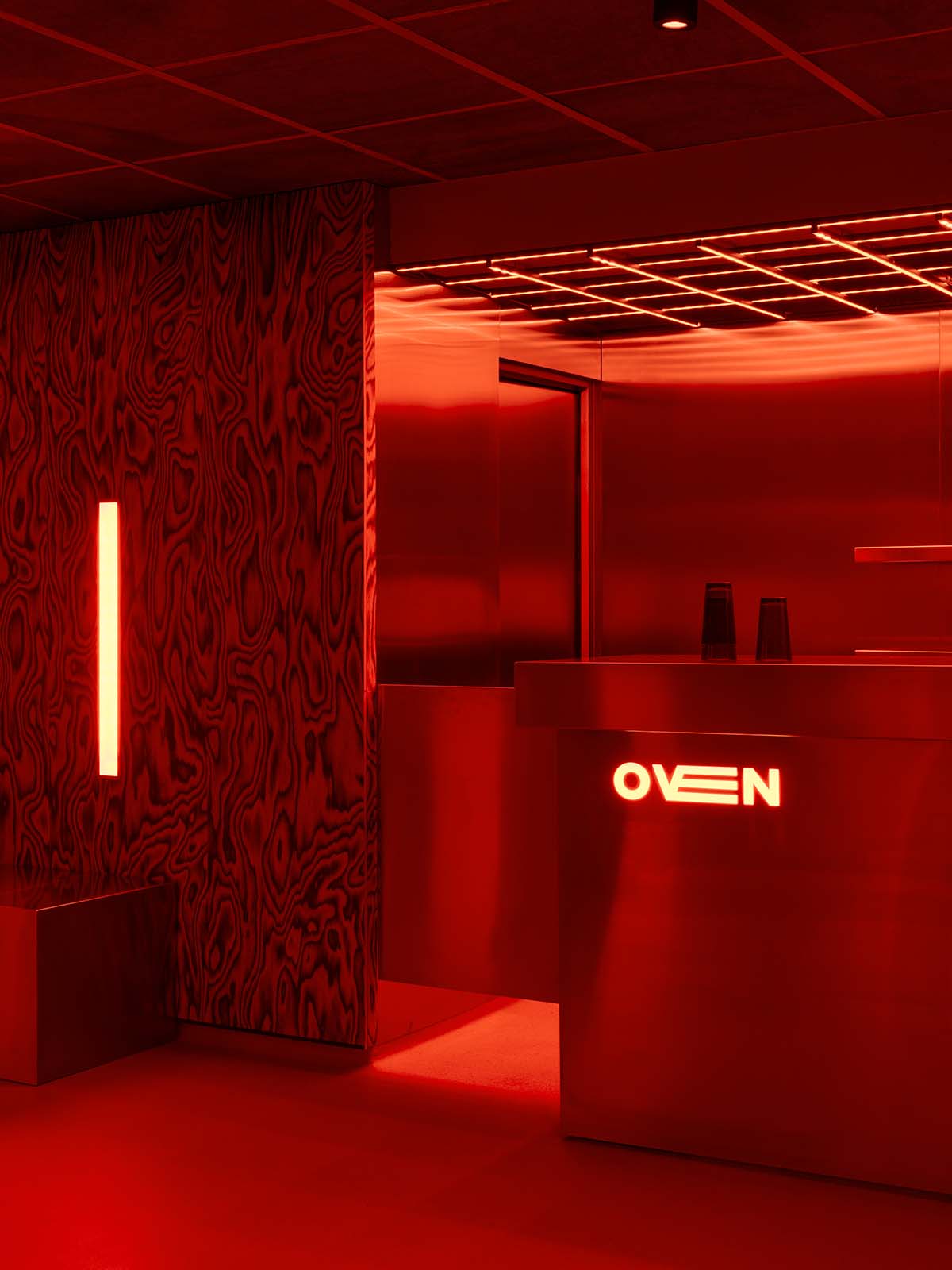 Bold red and black surfaces dominate the interior of the Oven Club, designed by Clap Studio