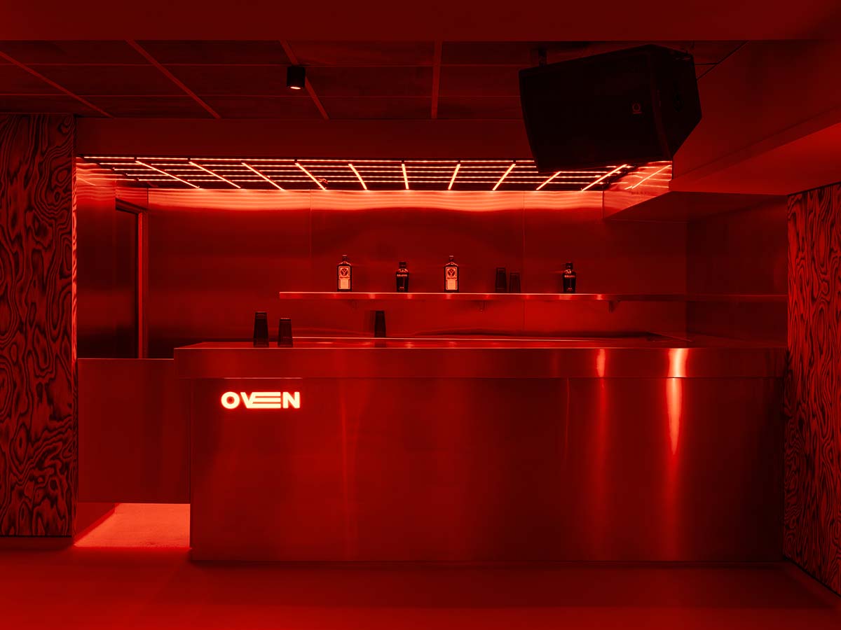 Bold red and black surfaces dominate the interior of the Oven Club, designed by Clap Studio