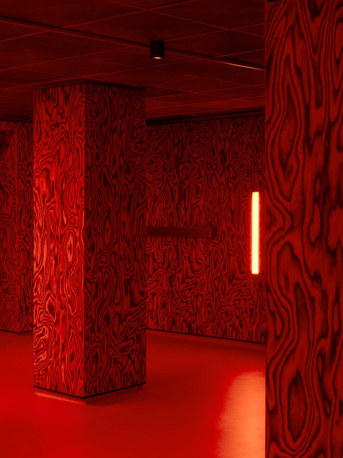 Bold red and black surfaces dominate the interior of the Oven Club, designed by Clap Studio