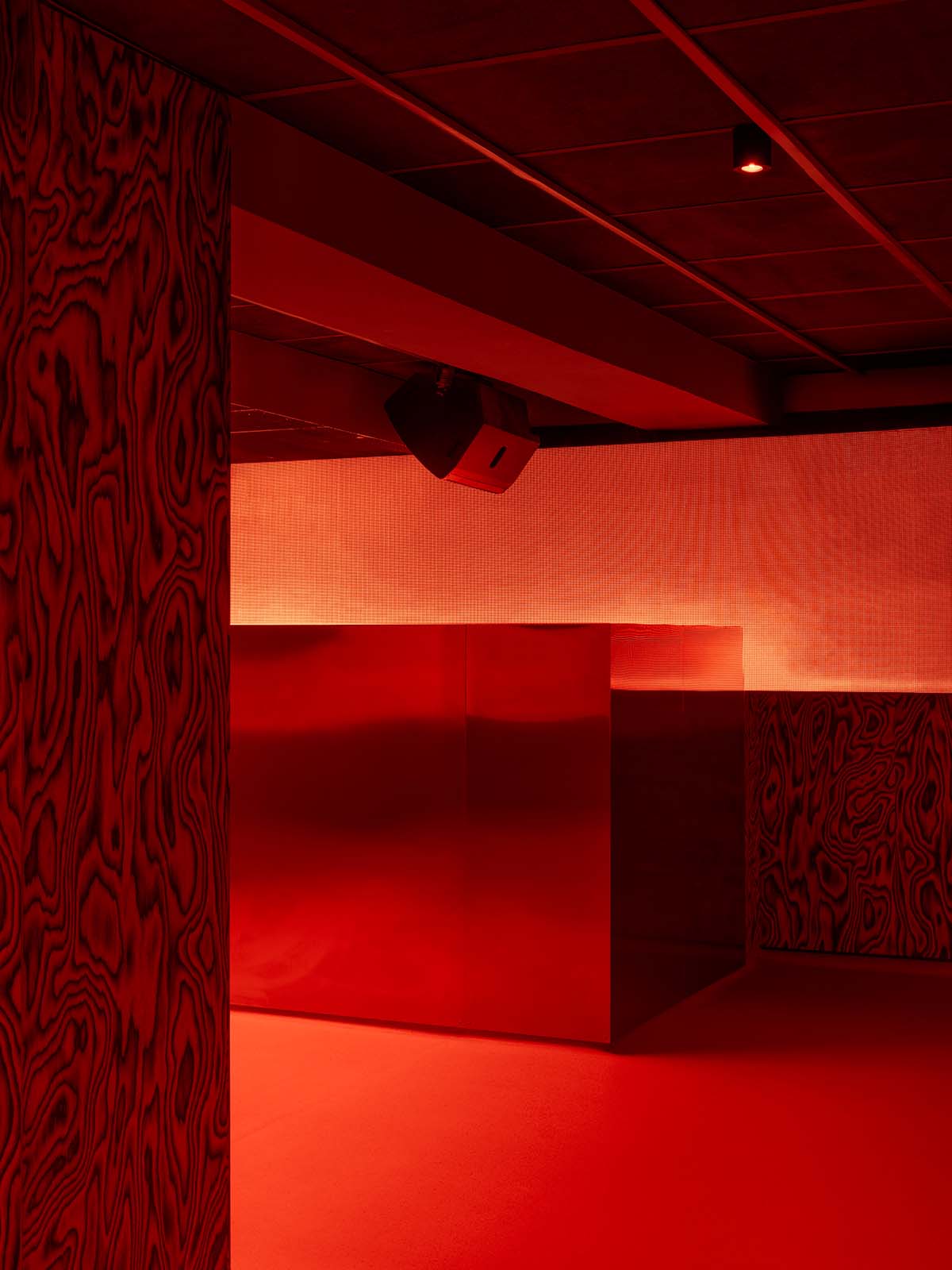 Bold red and black surfaces dominate the interior of the Oven Club, designed by Clap Studio