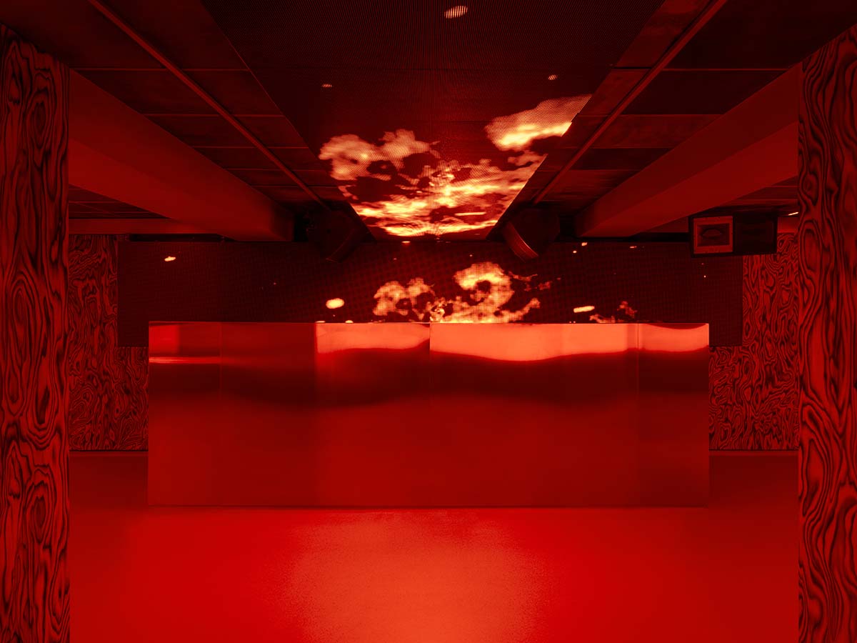 Bold red and black surfaces dominate the interior of the Oven Club, designed by Clap Studio