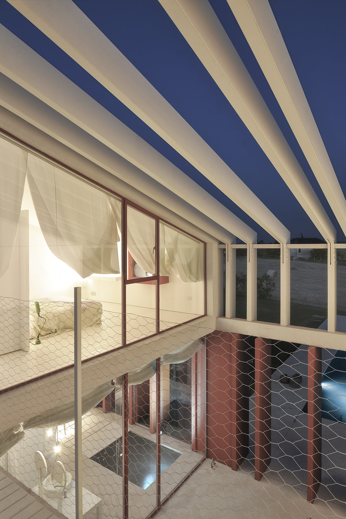 White and reddish strips are used to create cinematic appearance for Border Crossing House in Italy