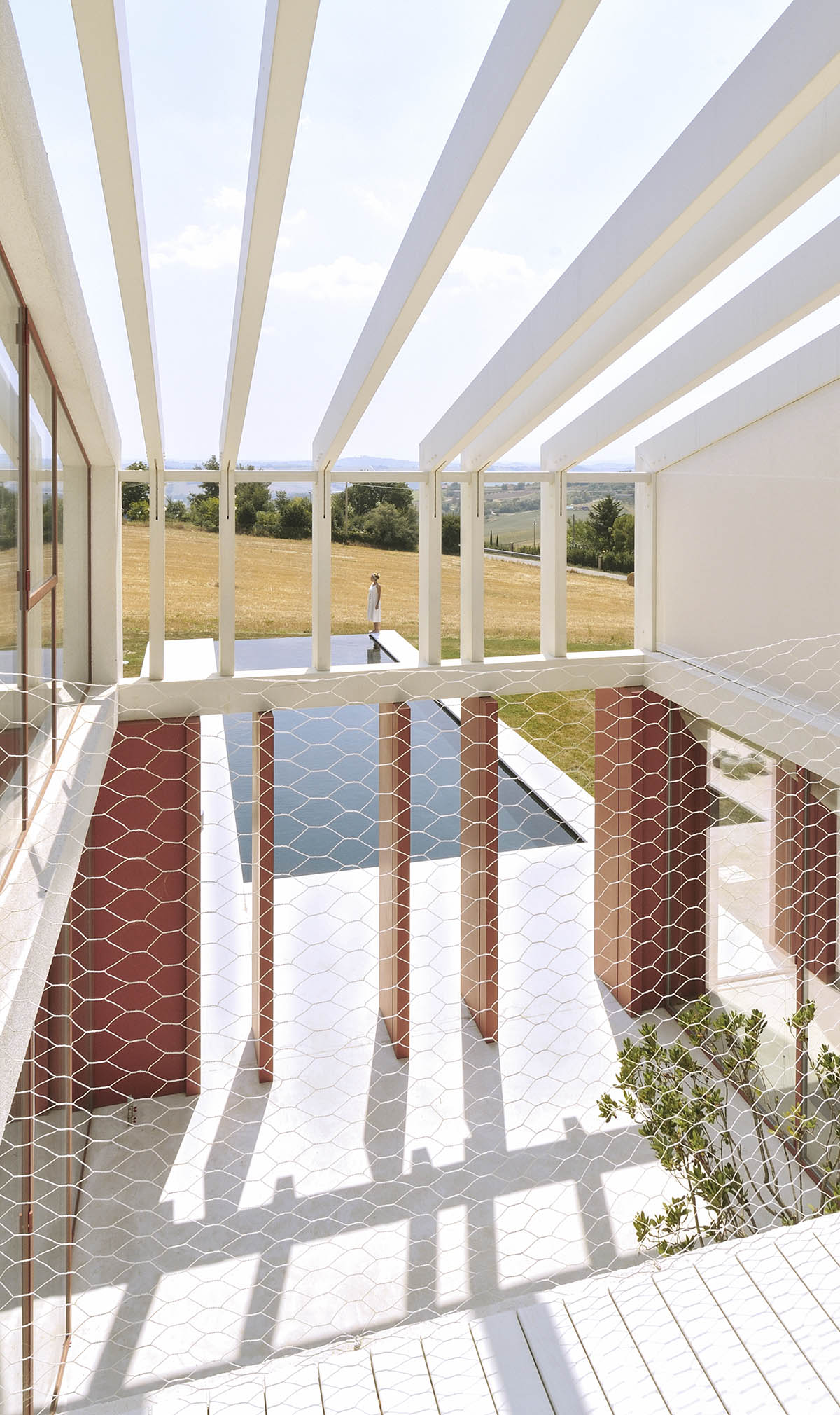 White and reddish strips are used to create cinematic appearance for Border Crossing House in Italy