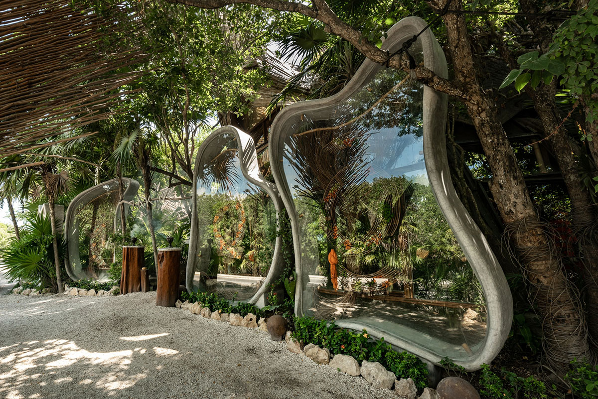 A wooden jungle wraps the interior of a fashion store in Tulum designed by Roth-Architecture