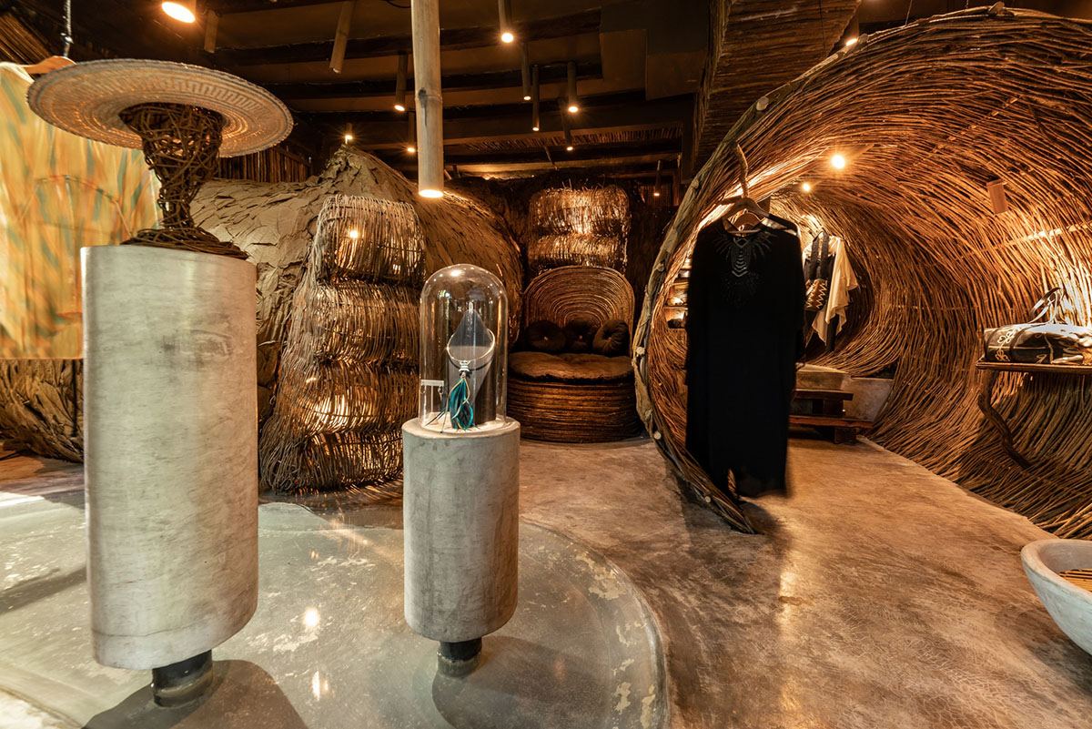 A wooden jungle wraps the interior of a fashion store in Tulum designed by Roth-Architecture