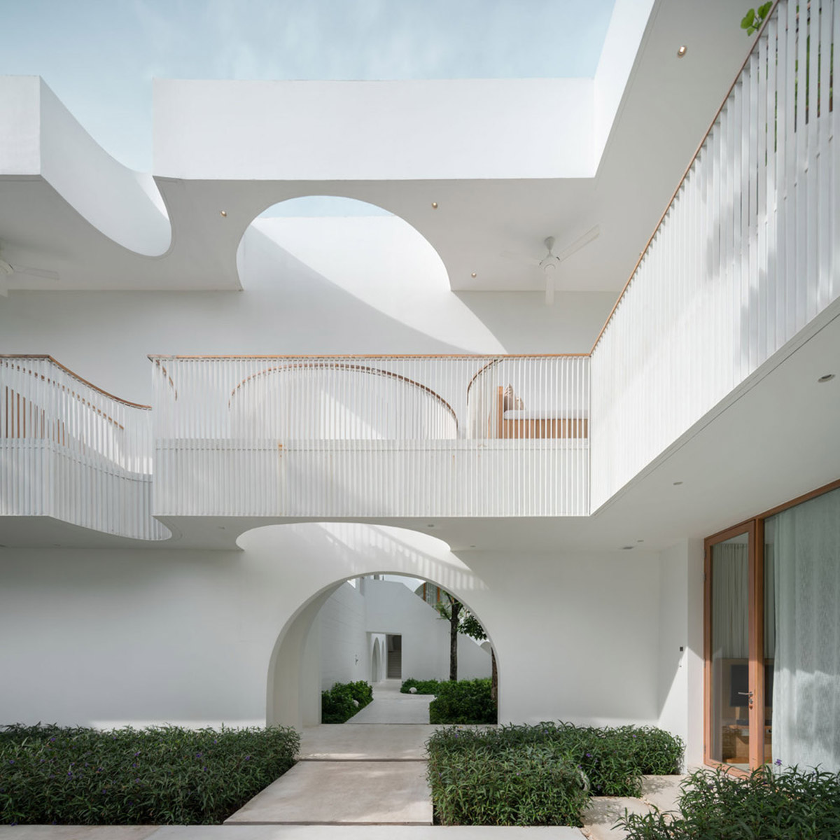 onion combines white concave and convex walls with colorful surfaces for beach resort in Thailand