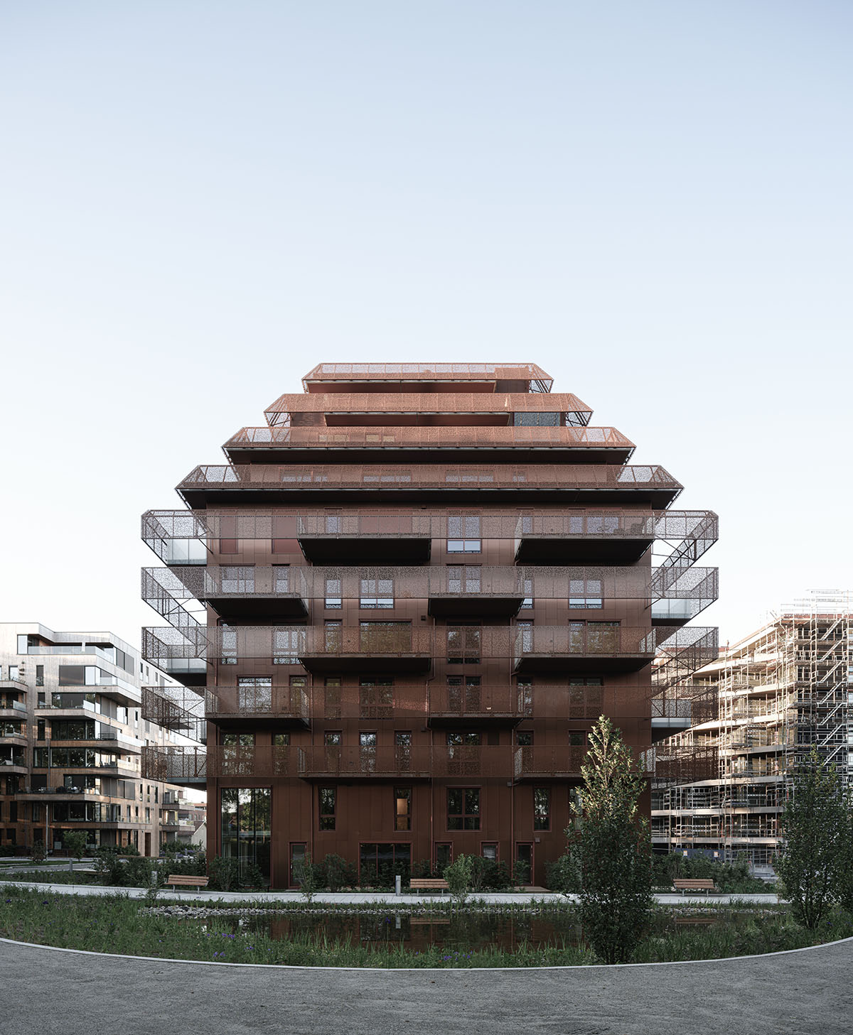 Reiulf Ramstad Arkitekter completes copper Ski Tårn housing wrapped in linear terraces in Norway