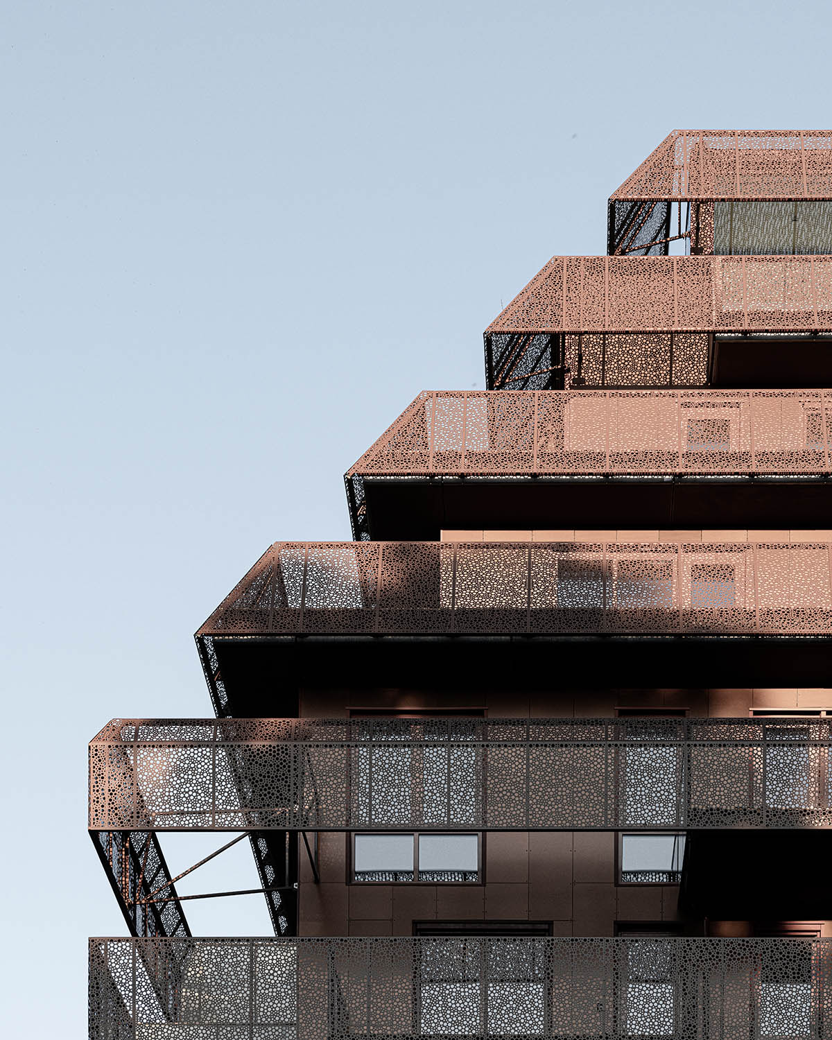 Reiulf Ramstad Arkitekter completes copper Ski Tårn housing wrapped in linear terraces in Norway