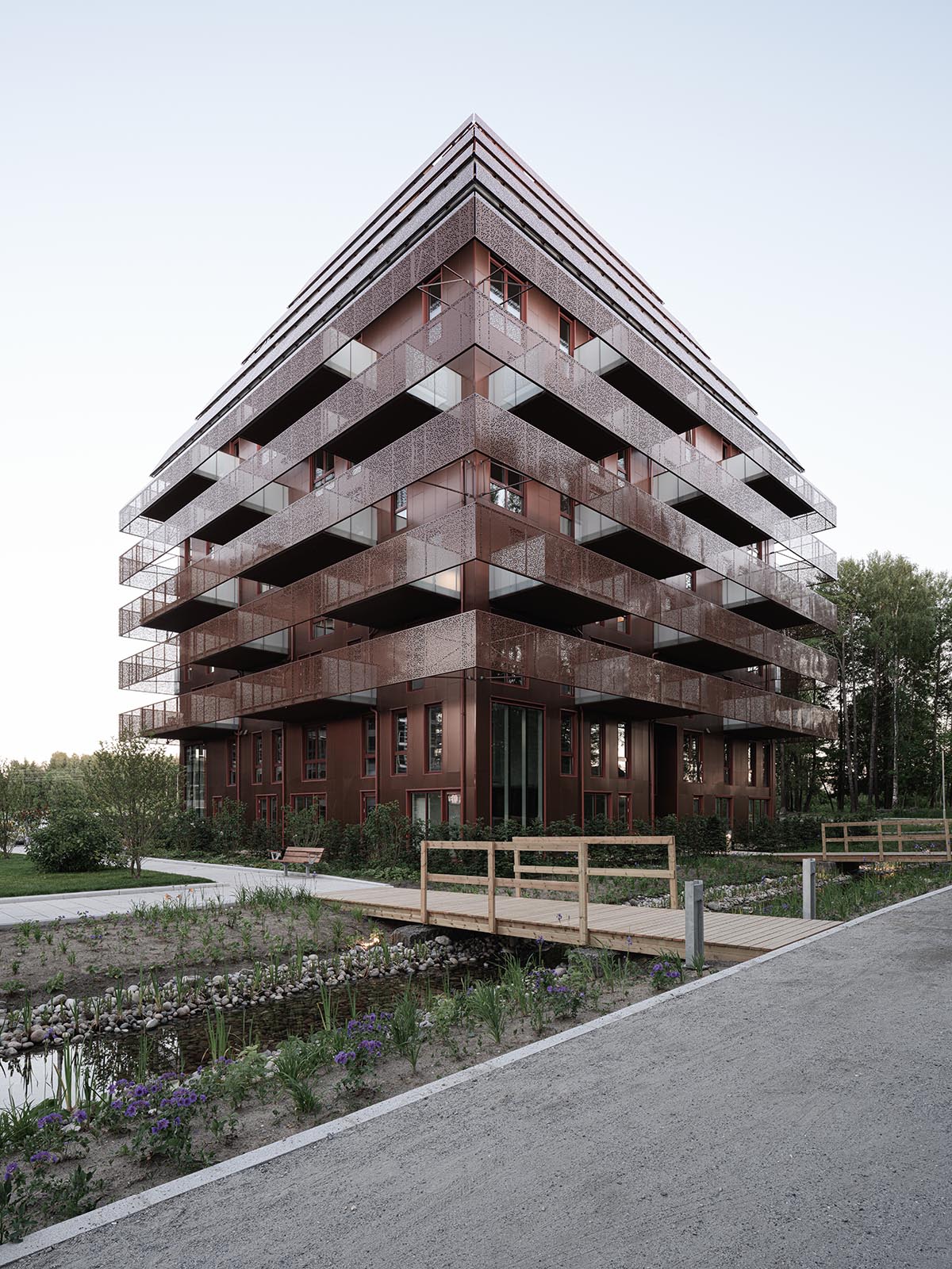 Reiulf Ramstad Arkitekter completes copper Ski Tårn housing wrapped in linear terraces in Norway