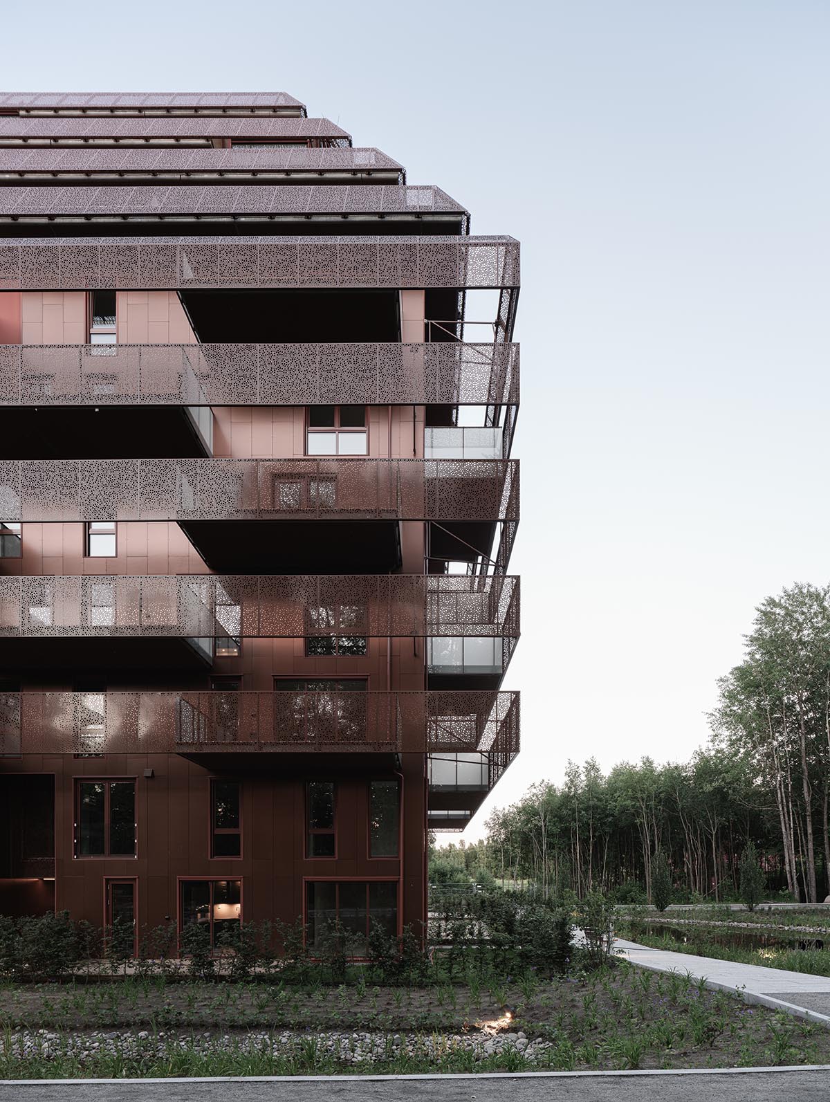 Reiulf Ramstad Arkitekter completes copper Ski Tårn housing wrapped in linear terraces in Norway