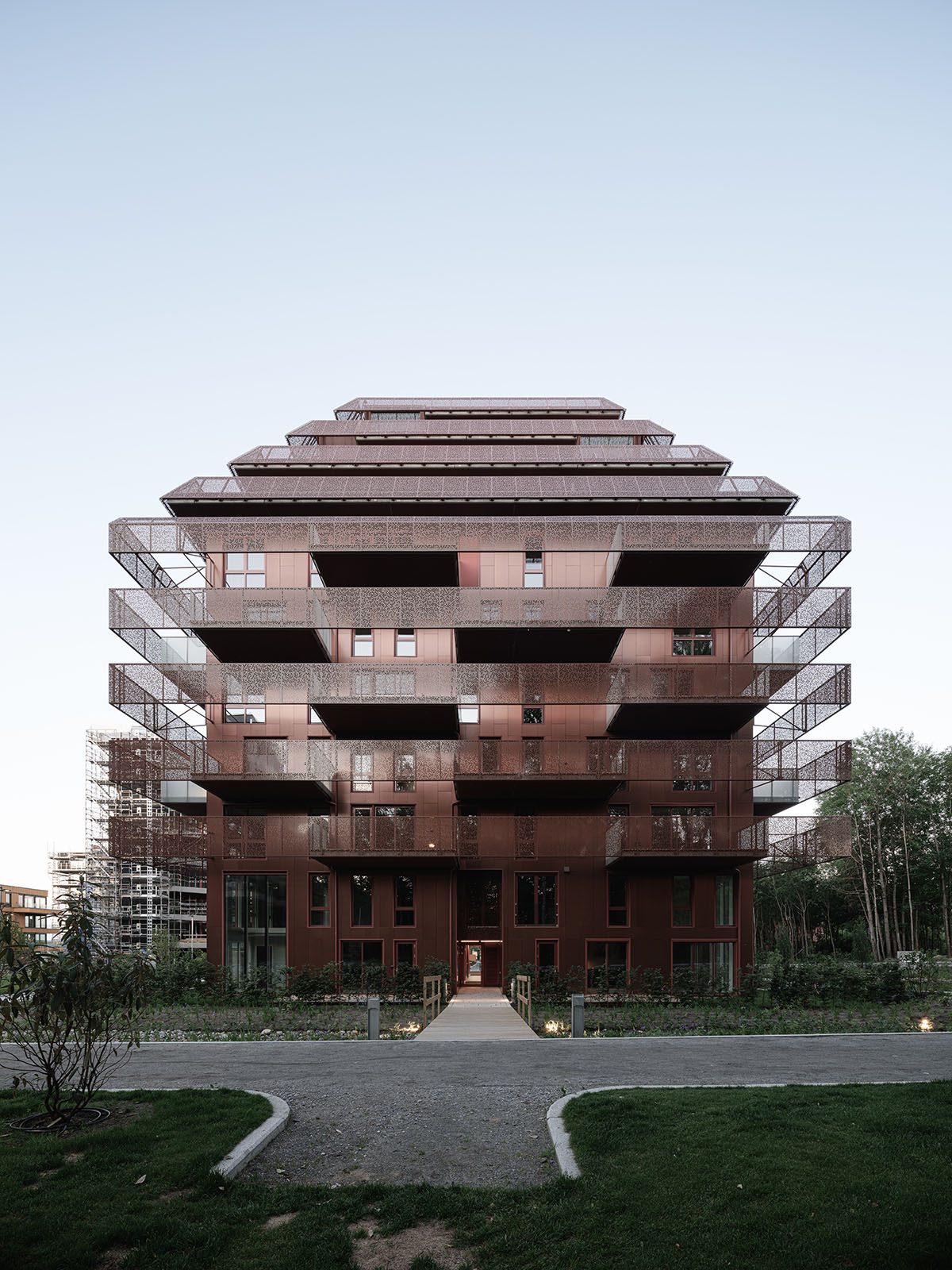 Reiulf Ramstad Arkitekter completes copper Ski Tårn housing wrapped in linear terraces in Norway