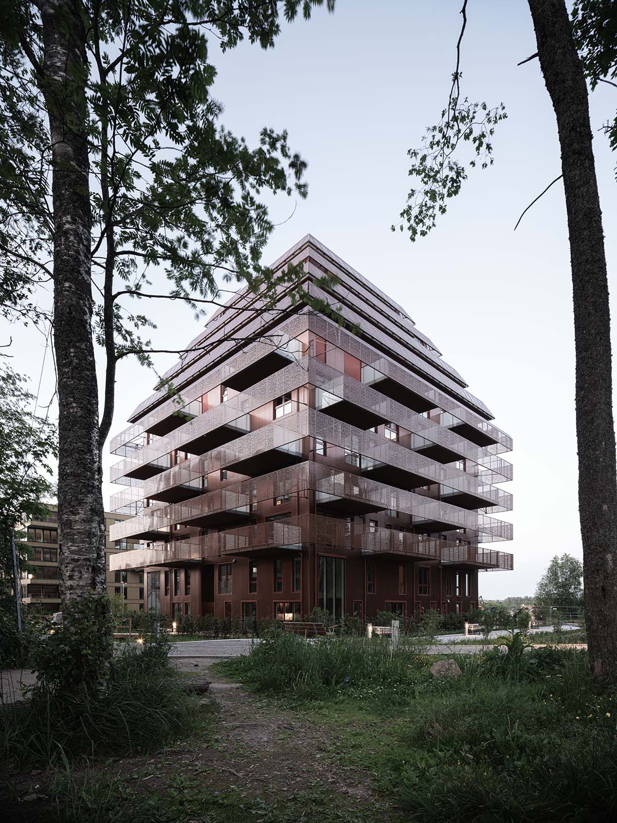 Reiulf Ramstad Arkitekter completes copper Ski Tårn housing wrapped in linear terraces in Norway