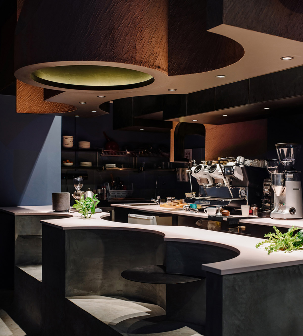 Studio SKLIM creates punctuated spaces and circular geometries to form this cafe in Singapore