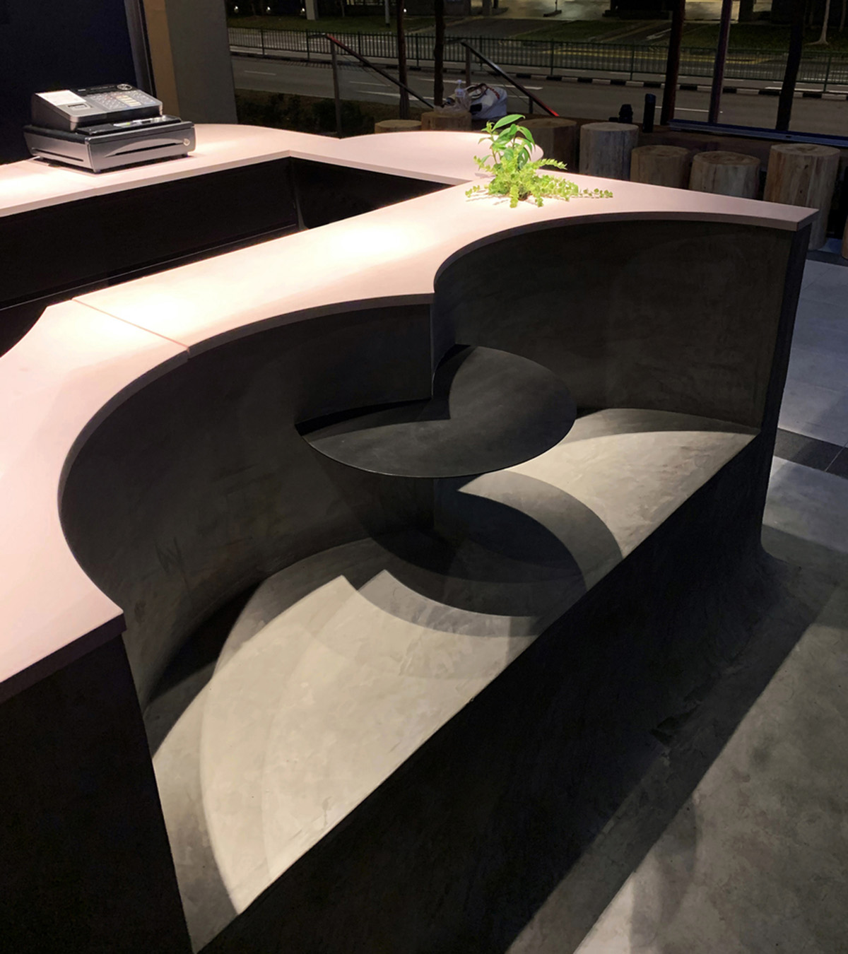 Studio SKLIM creates punctuated spaces and circular geometries to form this cafe in Singapore