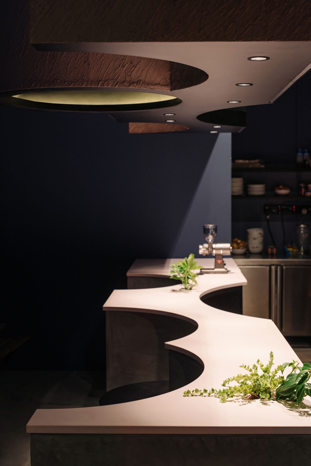 Studio SKLIM creates punctuated spaces and circular geometries to form this cafe in Singapore