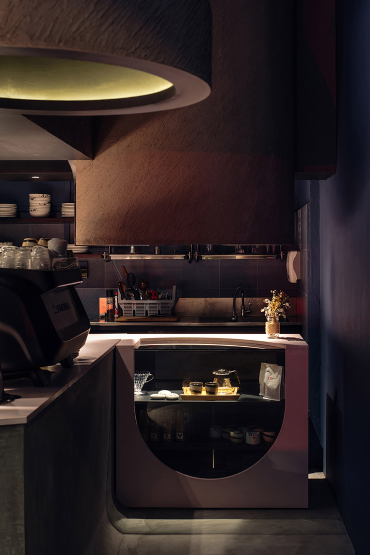 Studio SKLIM creates punctuated spaces and circular geometries to form this cafe in Singapore