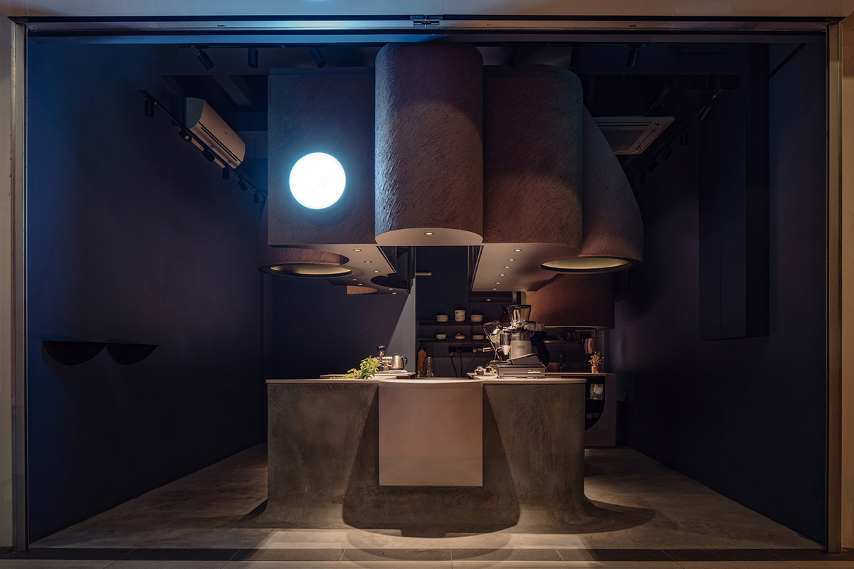 Studio SKLIM creates punctuated spaces and circular geometries to form this cafe in Singapore