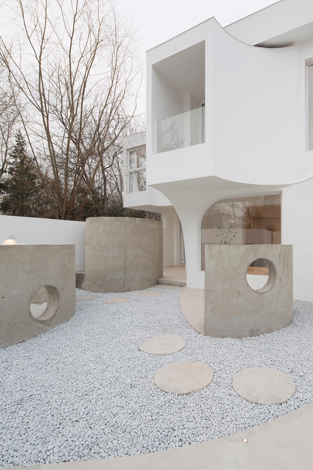 Boutique hotel by Atelier d'More is shaped by flowing curves and sculptural geometric compositions